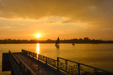 Cairo, Egypt  - Traditional boats named "Felluca"  in Nile River at sunset