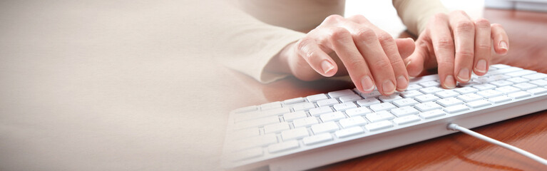 Hands typing on keyboard