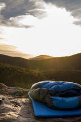 sleeping bag and pad laid out on top of a mountain - 155103903