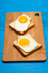 Toasts and egg on a blue wooden table