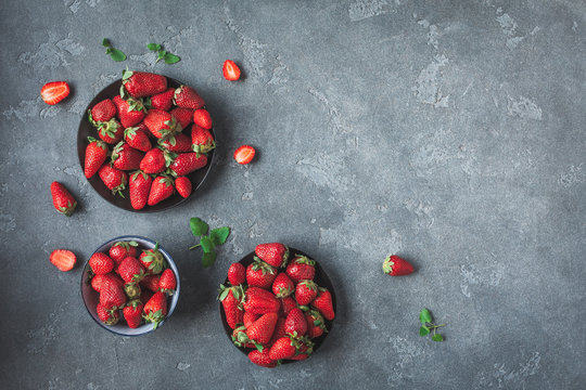 Fresh strawberry on black background. Flat lay, top view