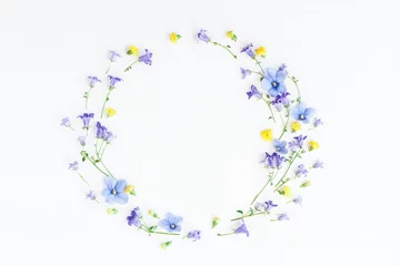 Foto op Plexiglas Wreath made of bell flowers, pansy flowers and yellow flowers on white background. Flat lay, top view © Flaffy