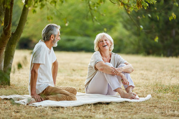 Happy senior citizens flirting in the park