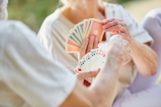 Two Retired Seniors Playing Cards As A Hobby