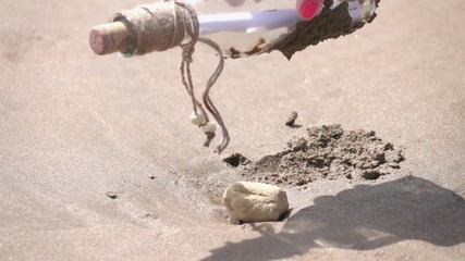 High quality video of picking up message in the bottle in real 1080p slow motion 250fps. More videos from this series in my portfolio