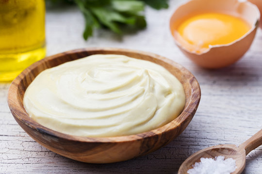Homemade mayonnaise, mayo in a wooden bowl.