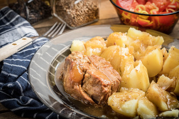 Stewed pork meat served with potatoes