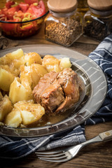 Stewed pork meat served with potatoes