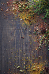 Mix of fresh thyme herbs and spices assortment on wooden background.