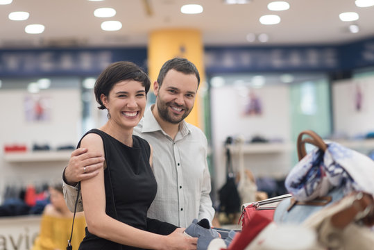 couple chooses shoes At Shoe Store