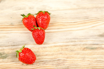 Ripe strawberry on a wooden background