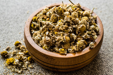 Dried Camomile flower tea in wooden bowl (papatya-bobune)