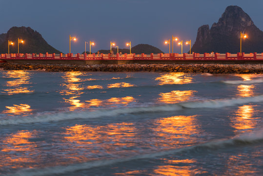 Prachuap Khiri Khan pier at night with mountains in the background