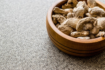 Dry Ginger in wooden bowl.