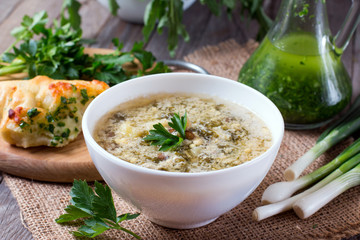 Sorrel soup with egg and greens in a plate