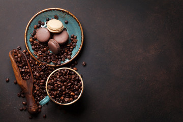 Coffee cup with roasted beans and macaroons