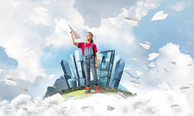 Concept of careless happy childhood with girl dreaming about future