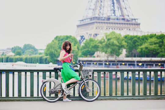 Woman riding a bicycle on a street of Paris