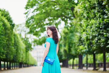 Beautiful young woman walking in Parisian Tuileries park