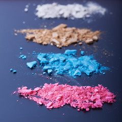 Background with colorful powder. Crushed eyeshadow on black background. Abstract background square