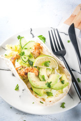 Healthy food snack. Tortillas taco with grilled chicken, avocado, fresh salsa, lettuce, lime. With yogurt & parsley sauce. On light gray stone marble table, marble plate. Copy space