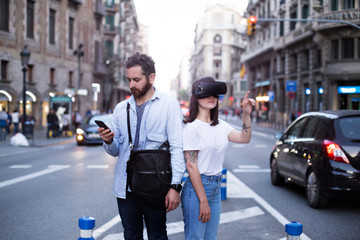 Fototapeta premium Serious and concentrated couple or two friends or coworkers analize the environment around them with the Virtual reality googles
