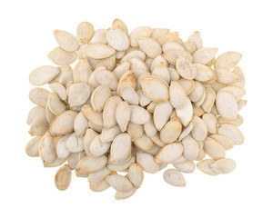 Top view of roasted and salted pumpkin seeds pile isolated on a white background.