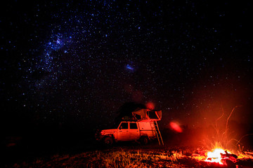 Camping with campfire and stars.