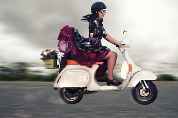 Fototapeta na wymiar Vintage girl riding a motorcycle