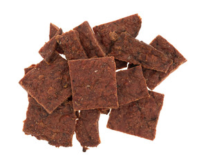 Top view of several pieces of peppered beef jerky isolated on a white background.