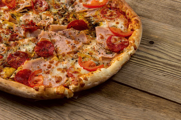Hot and tasty Pizza Ready to Eat  on a wooden background.