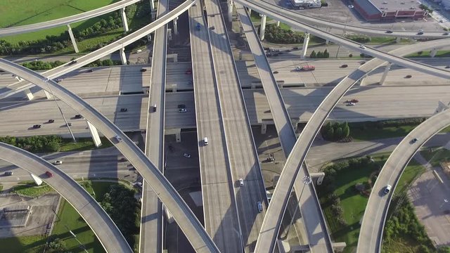 Aerial view massive highway intersection, stack interchange with elevated road junction overpass in the afternoon at Houston, Texas. This five-level freeway interchange carry heavy rush hour traffic.