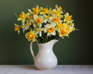 Bouquet of yellow daffodils in a white jug