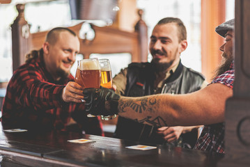 Joyful males drinking in bar
