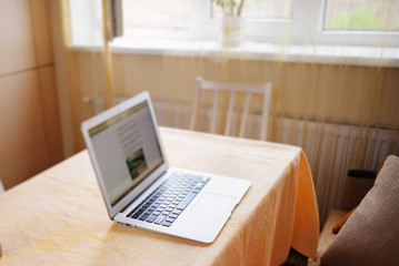Laptop with white screen on marble table