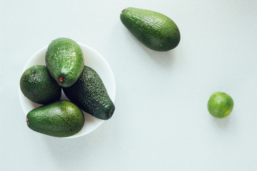 Fresh organic avocado in white ceramic bowl.