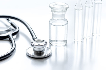 medicine set with stethoscope and vials on doctor's workplace background