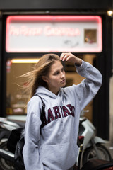 Beautiful american girl explores foreign new city on her summer exchange program in europe, wind in blonde hair