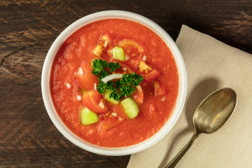 Bowl of gazpacho soup on rustic texture with copyspace