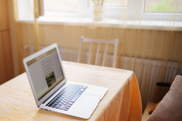 Laptop with white screen on marble table