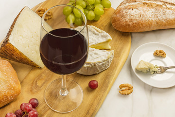 Wine and cheese tasting with bread, grapes and copyspace