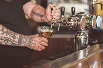 Bartender pouring fresh light ale