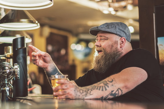 Man drinking light lager in pub