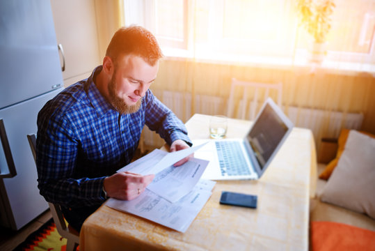 Handsome Man Doing Some Paperwork At Home