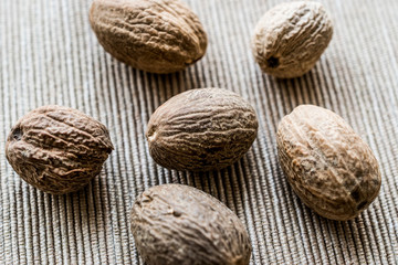 Organic Nutmeg or muskat on fabric surface.