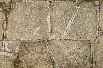 Old stone slabs of pavement surface closeup as background