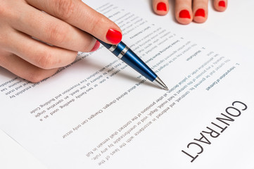 Business woman signing contract document in office