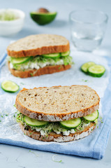 Ricotta sprouts avocado cucumber rye sandwich
