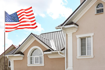 Waving USA flag and house on background