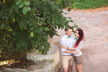 Fototapeta premium Young couple in love embracing in park, happy people outdoors